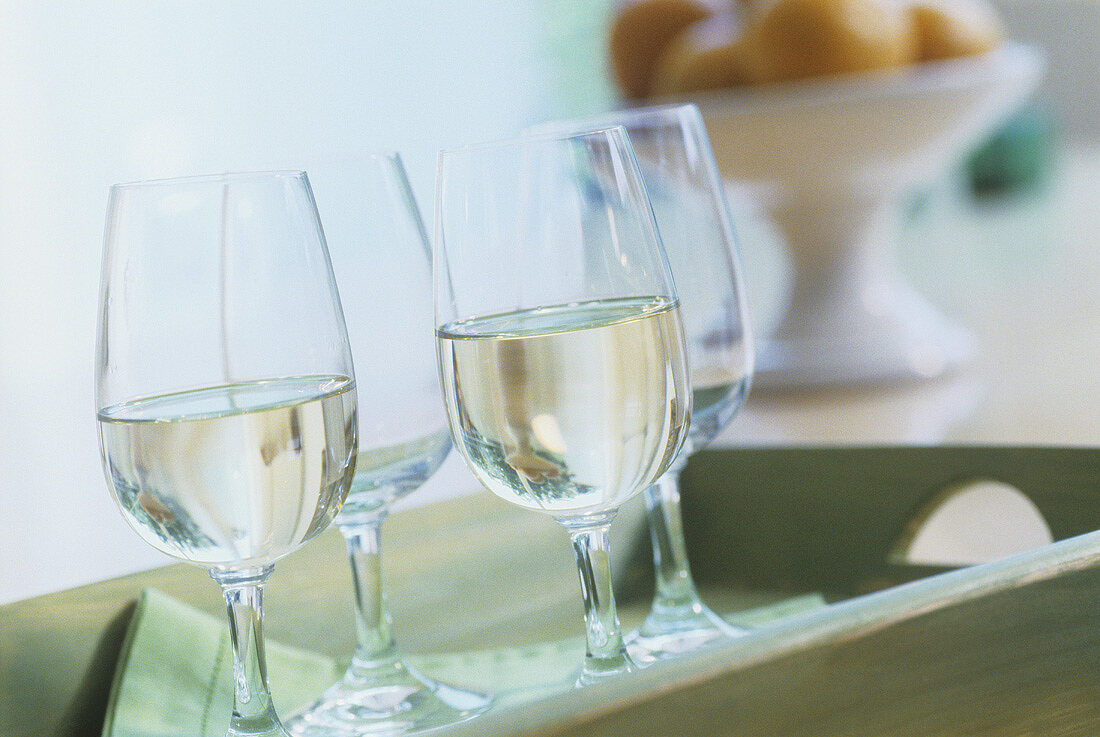 White wine in glasses on a tray