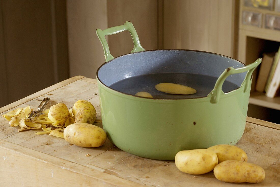 Peeled potatoes in a pot
