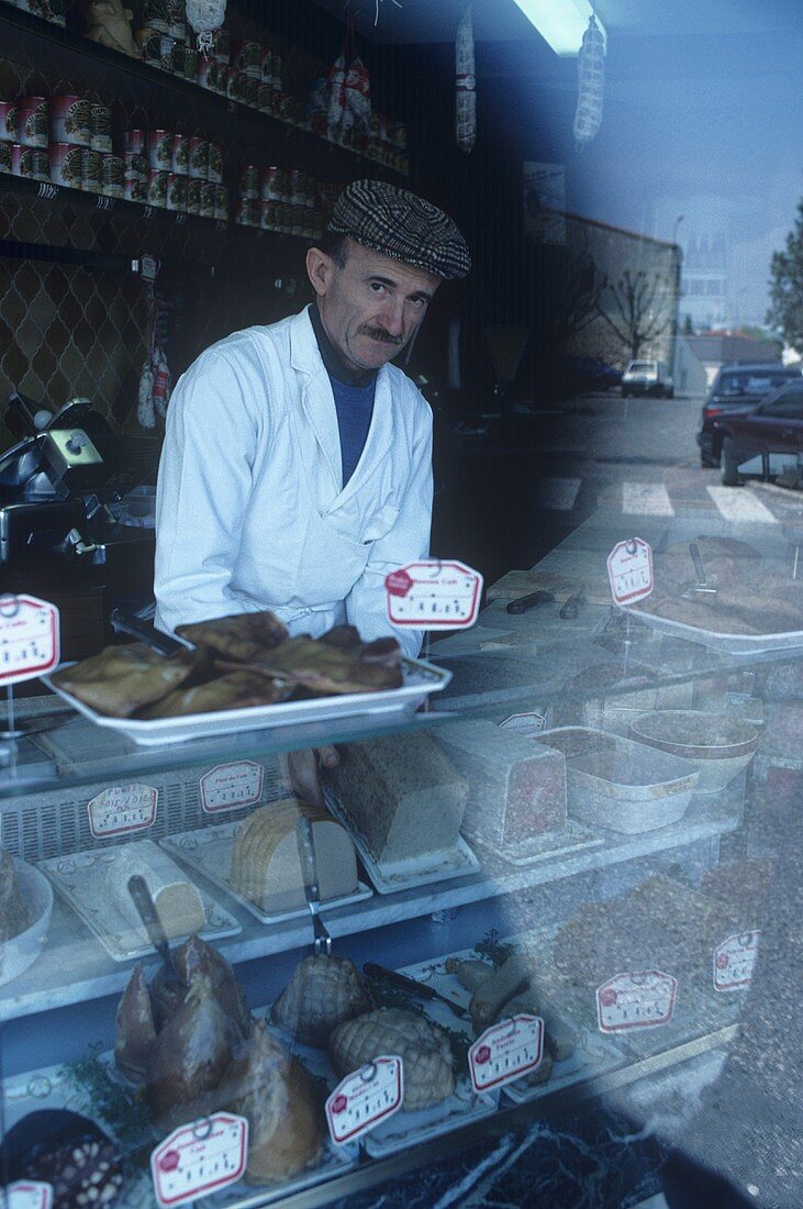 Butcher behind counter, Pauillac, France
