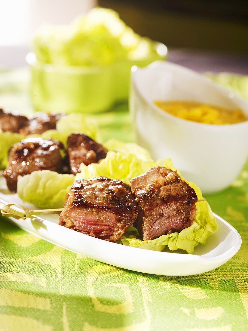 Beef kebabs on lettuce leaves