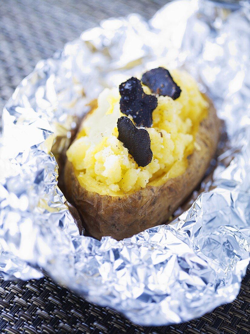 A jacket potato with black truffles