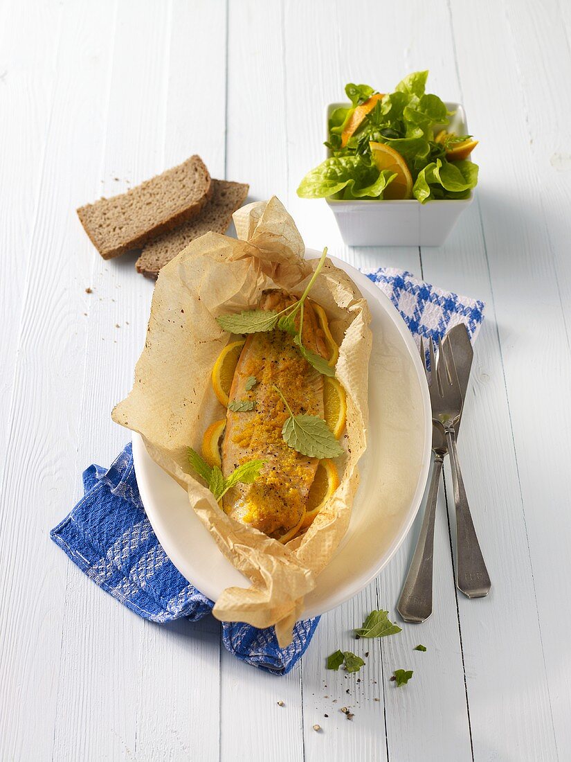 Fillet of char with oranges in parchment paper