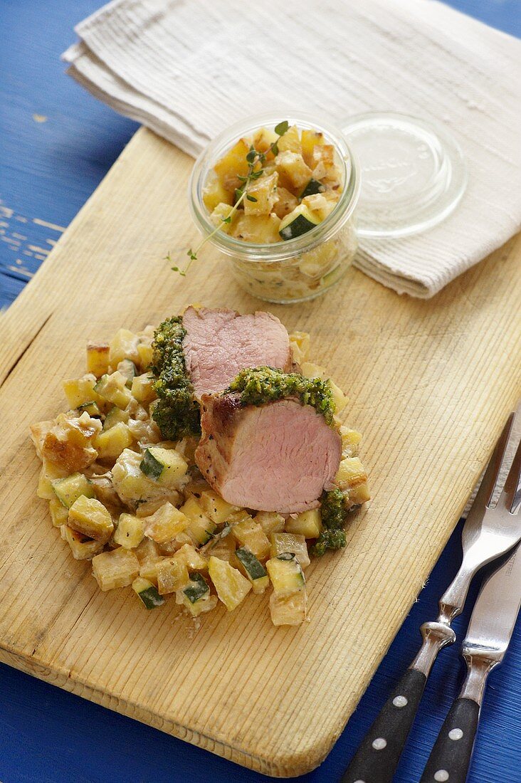 Pork fillet with a herb crust and a courgette medley
