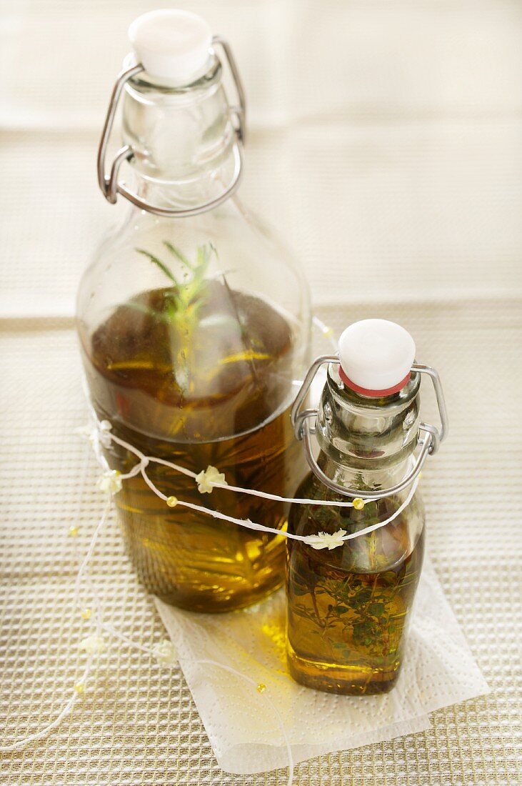Two bottles of olive oil with herbs