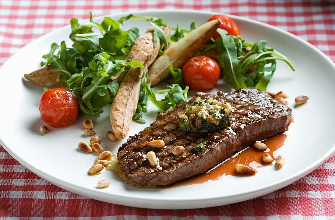 Beef steak with pine nuts, vegetables and rocket