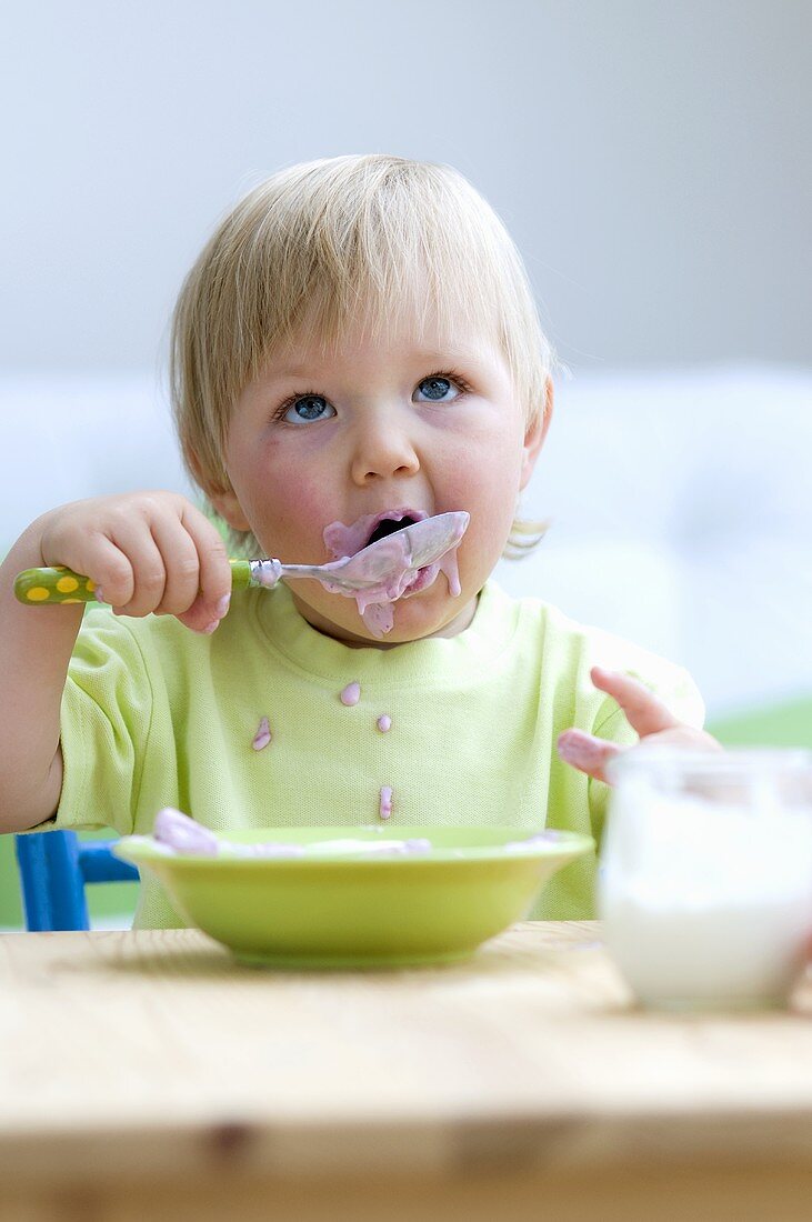 Toddler eating baby food