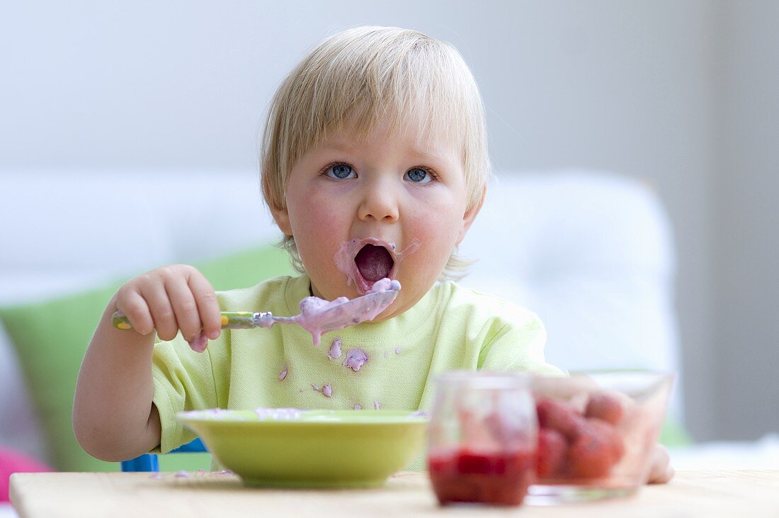 Toddler eating baby food