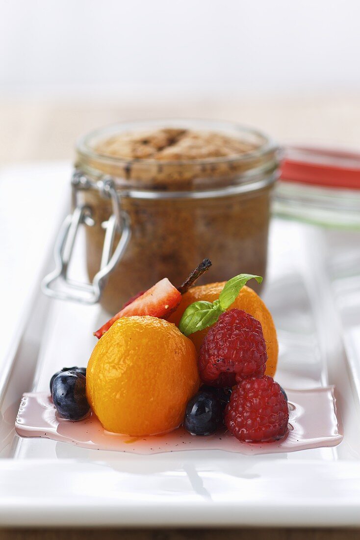 Chocolate souffle in a jar with marinated fruit