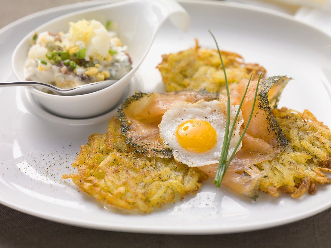 Potato cakes with salmon and fried egg with a cauliflower remoulade