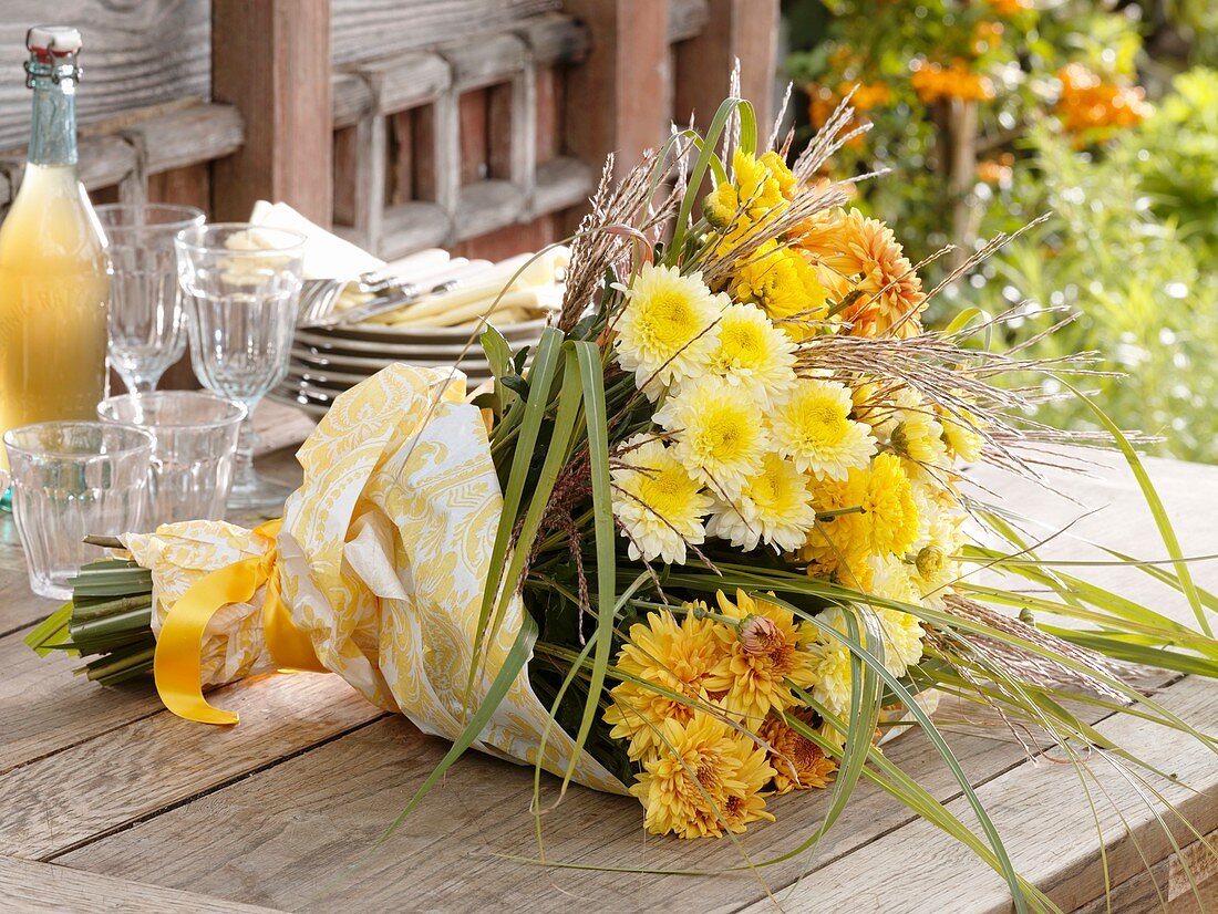 Bouquet of yellow chrysanthemums and Chinese silver grass