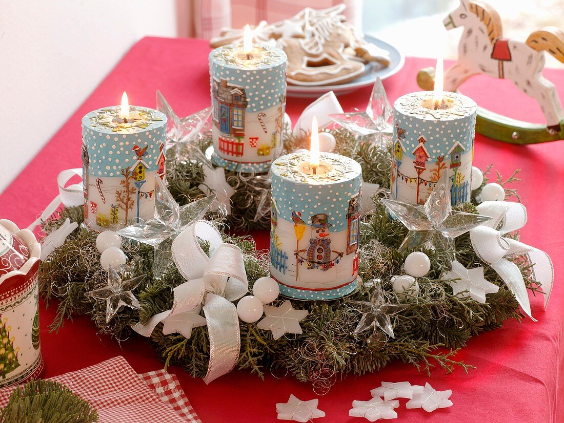 Advent wreath of cypress and fir with motif candles