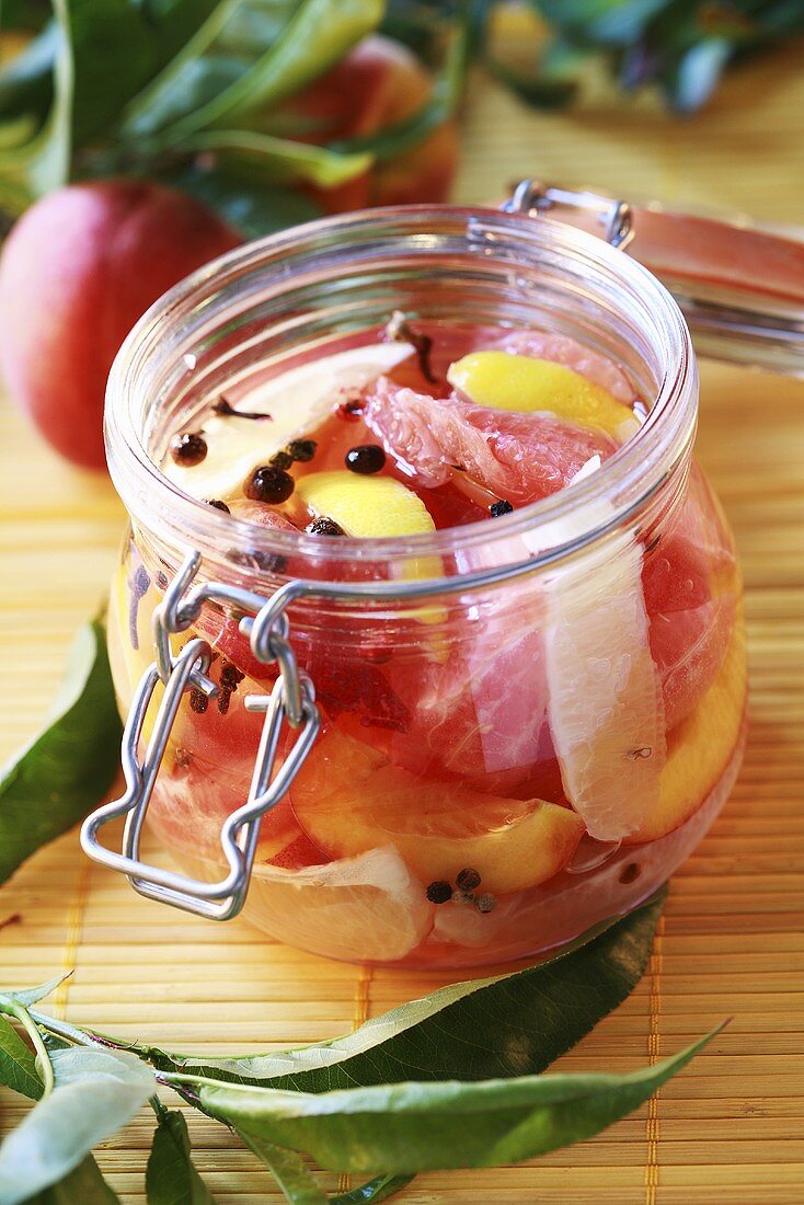 Spicy bottled peaches in preserving jar