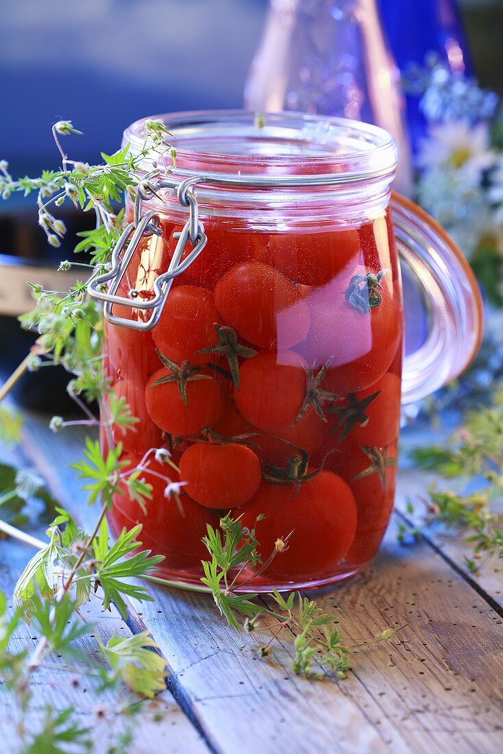 Bottled cherry tomatoes in preserving jar