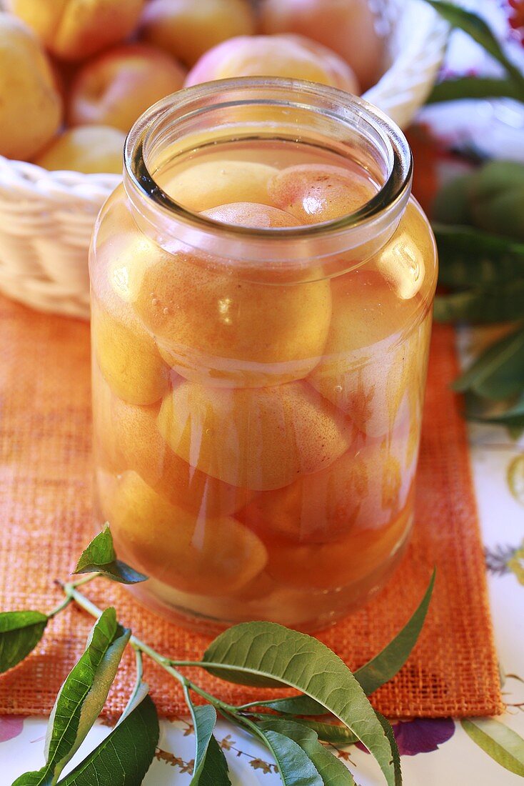 Stewed apricot and plum fruit in jar, close-up