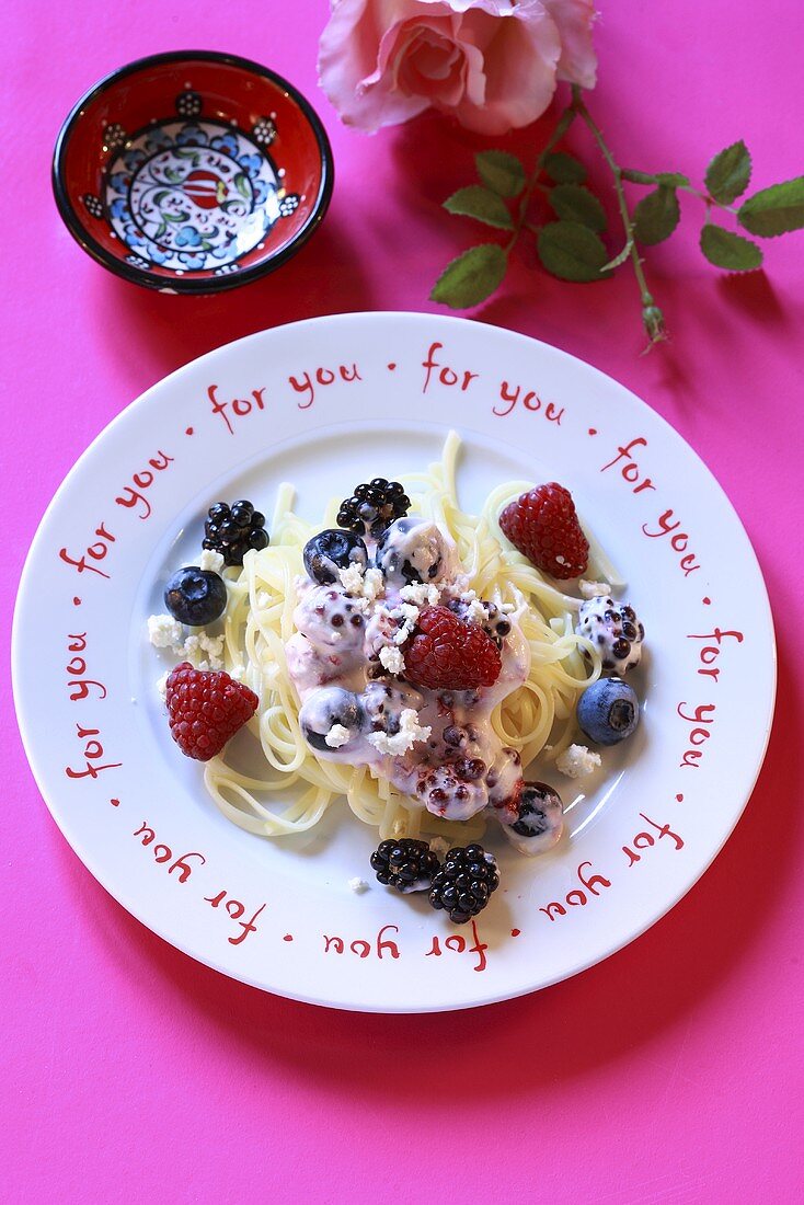 Ribbon pasta with berries and soft cheese