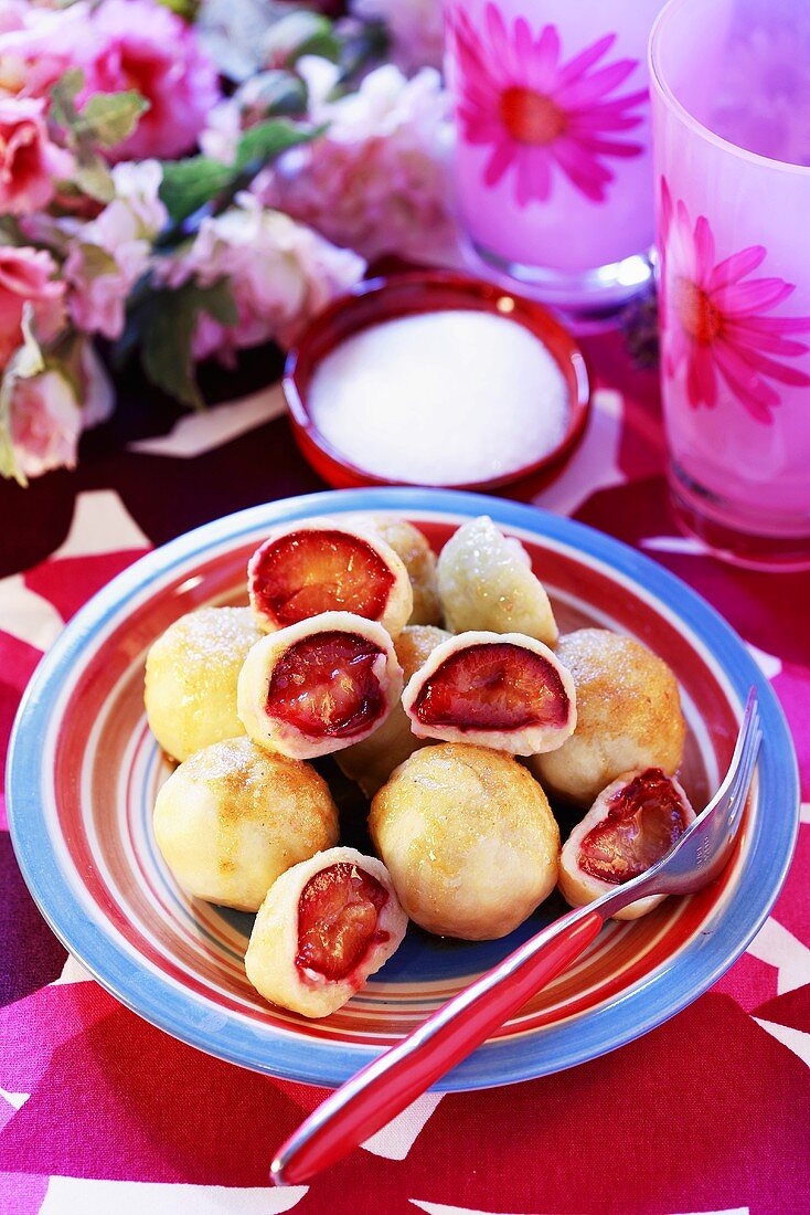 Plum dumplings on coloured plate