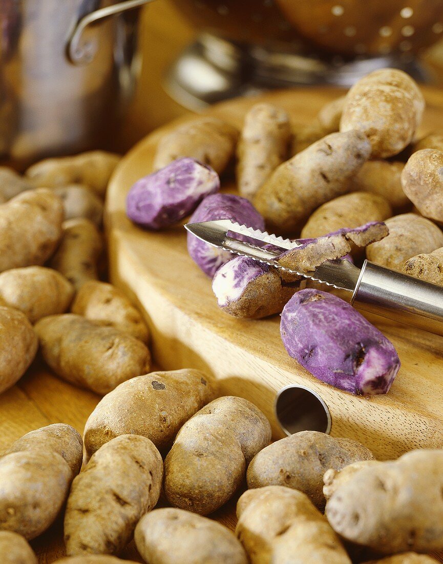 Purple potatoes, variety 'Russian Blue', on wooden board