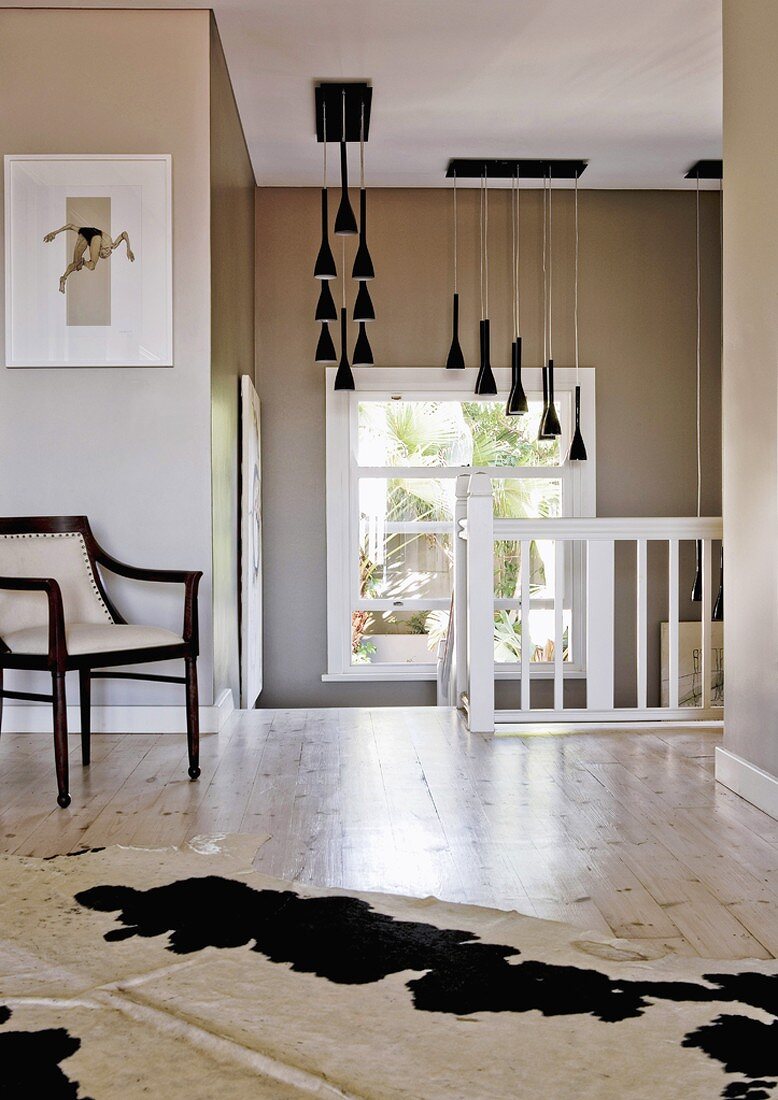 Chair and cowhide rug on landing