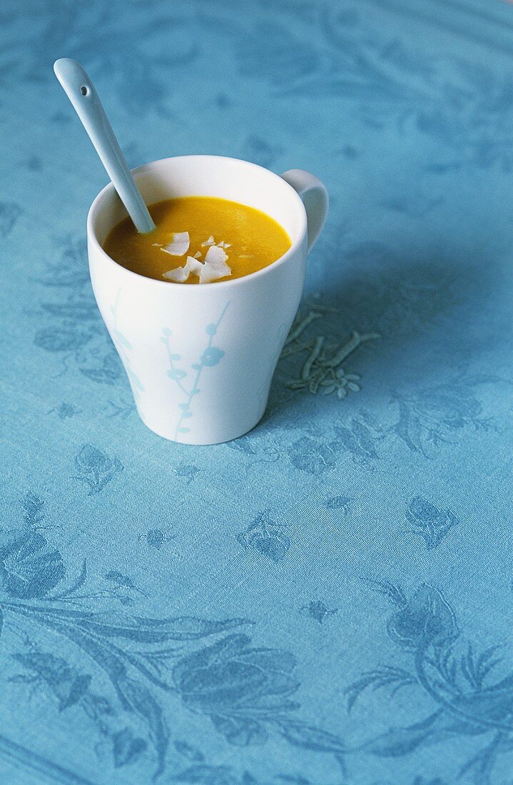 Carrot soup with ginger and coconut milk in cup