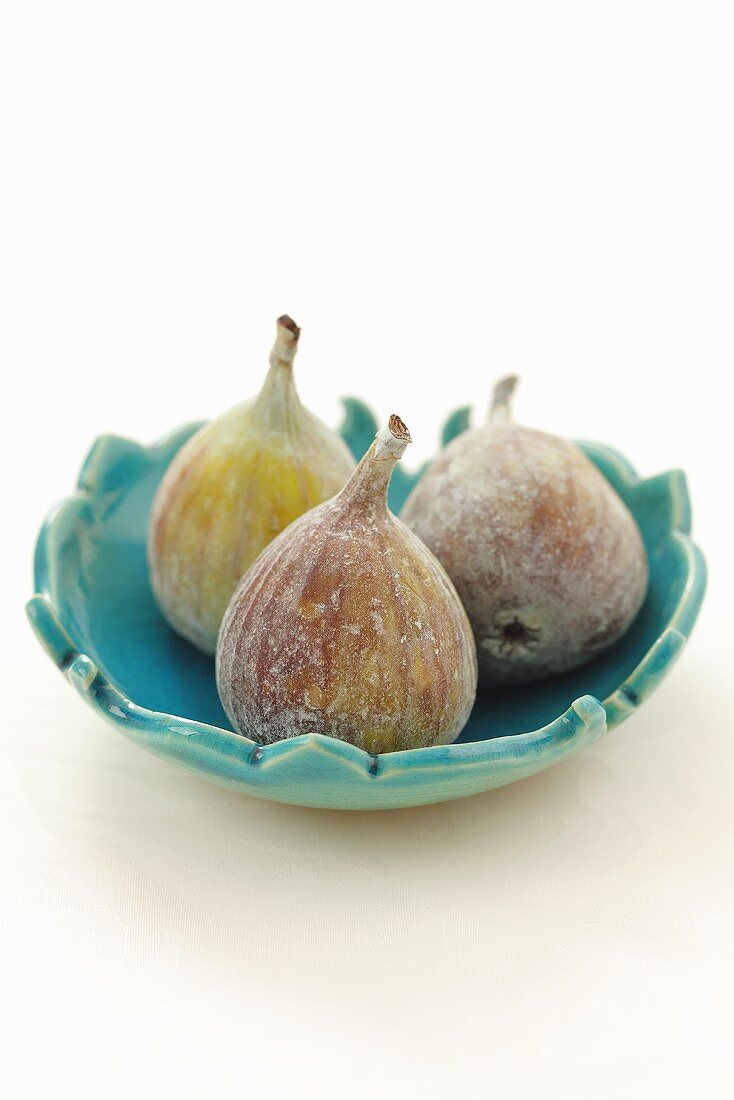 Three figs in a bowl