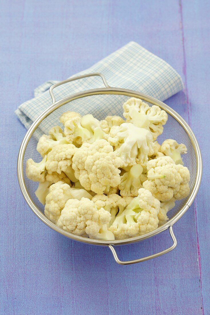 Cauliflower florets in a sieve