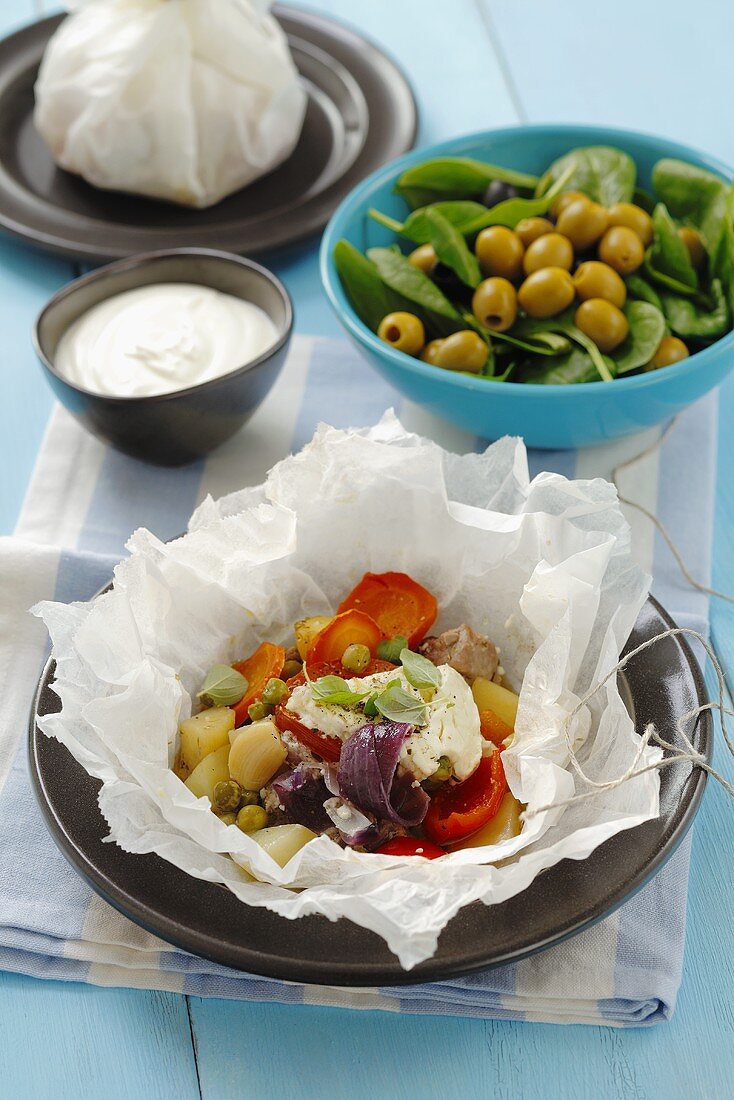 Pork with vegetables and sheeps' cheese in parchment paper