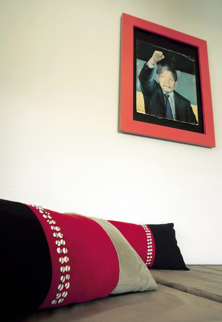 Portrait of Nelson Mandela hanging on wall above sofa