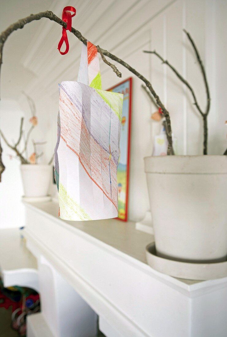 Flowerpot and child's drawing on a mantelshelf