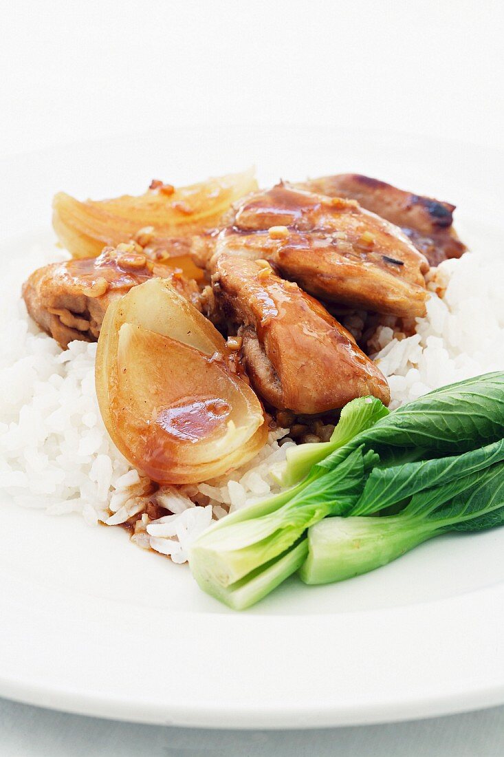 Lemon and honey chicken with onions, pak choi and rice