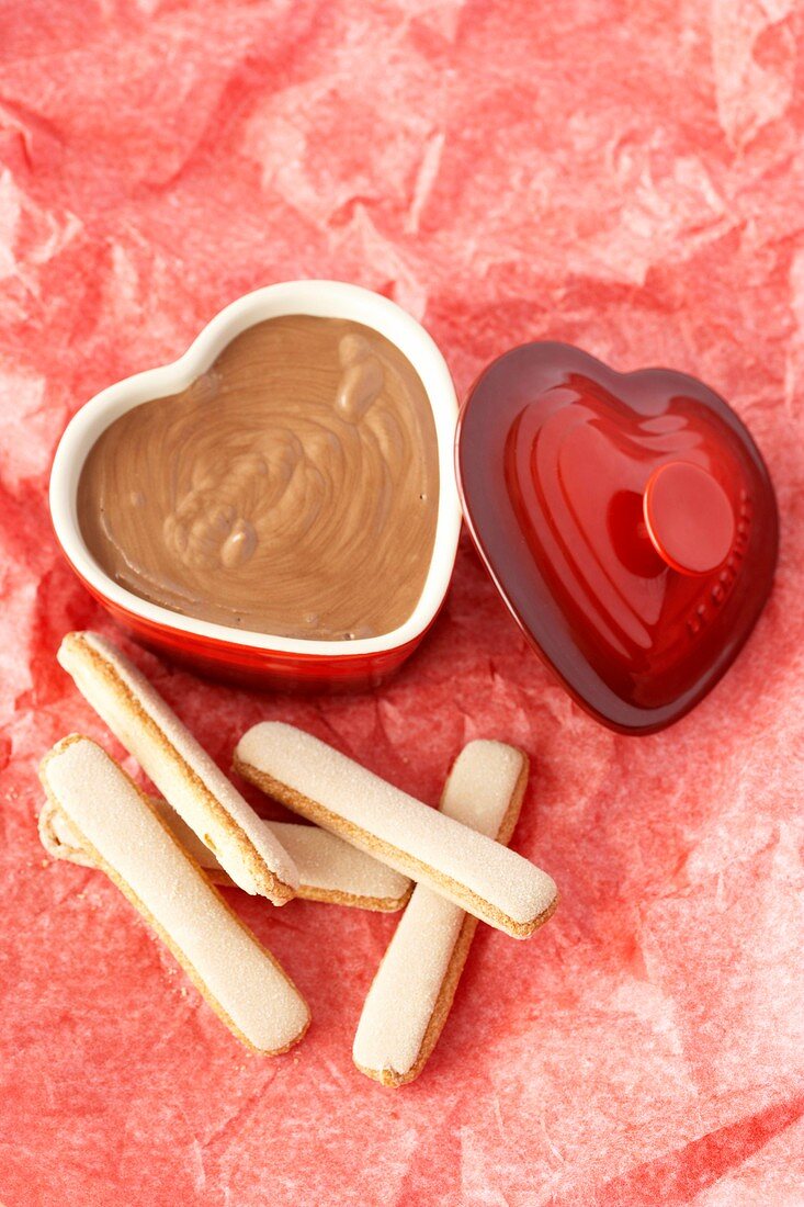 Chocolate mousse in heart-shaped dish, sponge fingers
