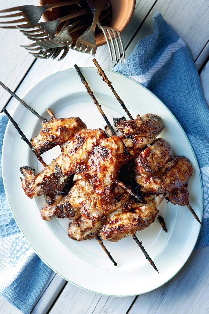 Grilled chicken wings on skewers