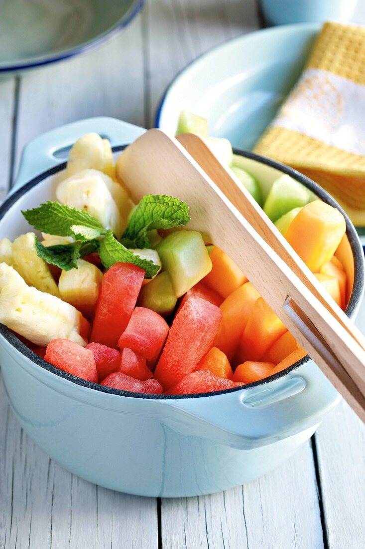 Melon and pineapple salad with mint leaves