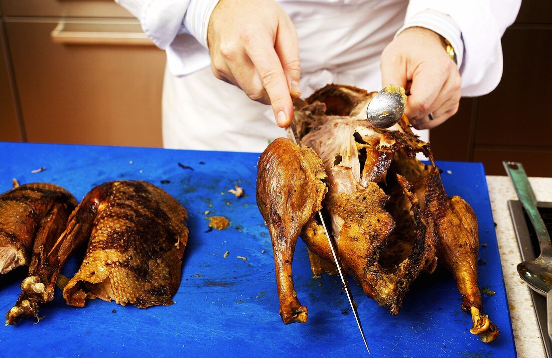 Chef carving roast goose