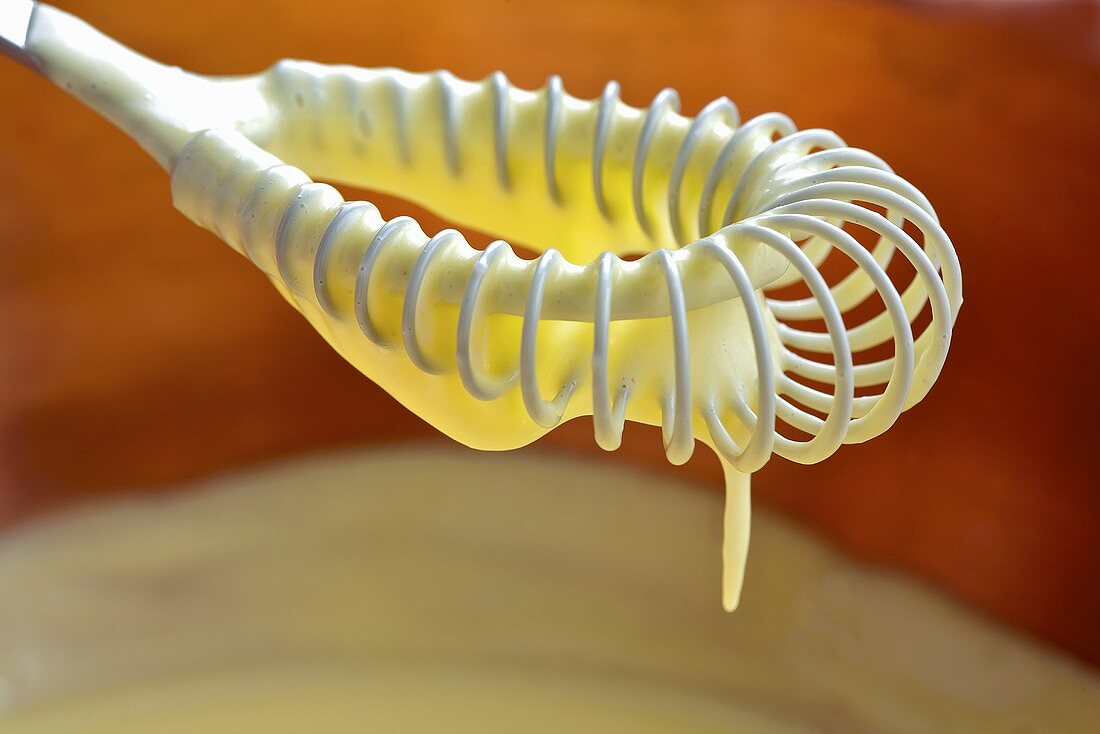 Mayonnaise dripping from whisk