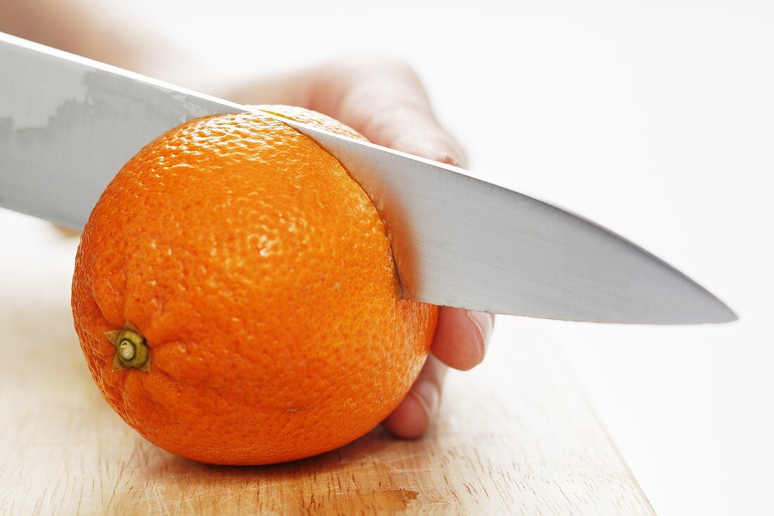 Cutting an orange in half