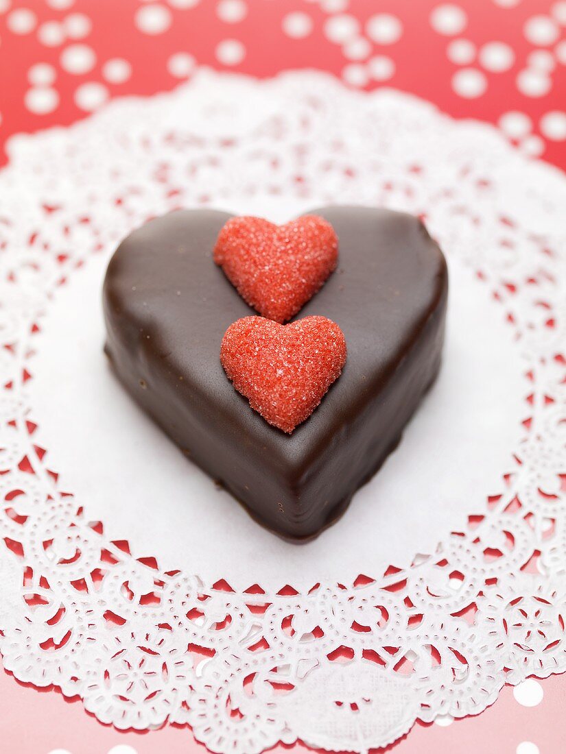 Small chocolate cake with sugar hearts