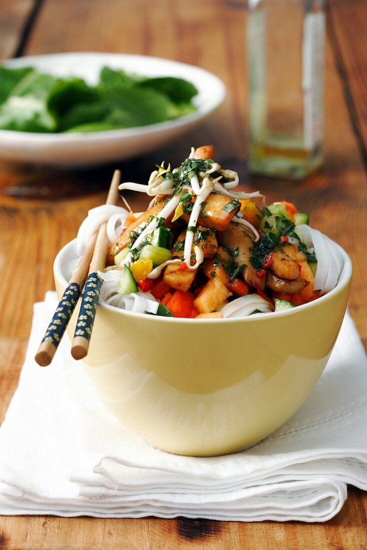 Asian seafood salad with fruit on a bed of rice noodles