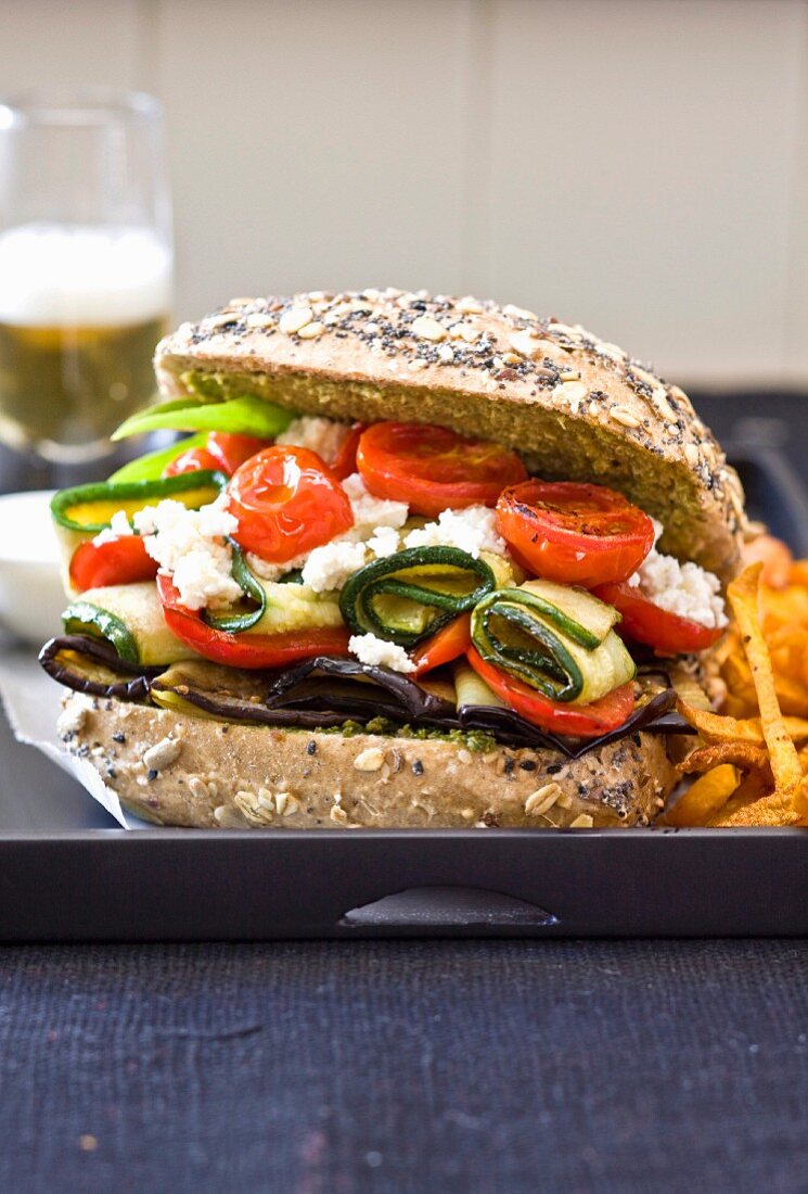 Bread roll filled with aubergine, courgettes, tomatoes and feta