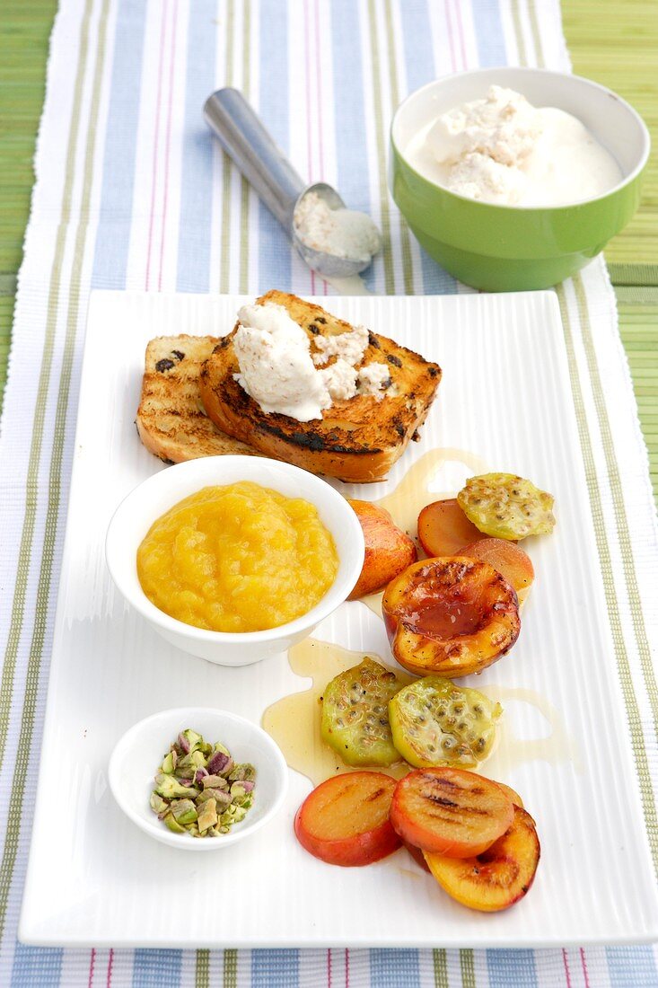 Barbecued fruit, mango sauce and coconut ice cream on toast