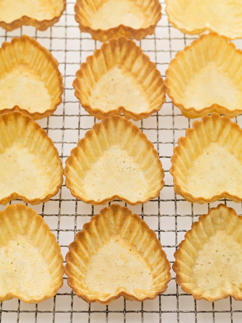 Heart-shaped pastry shells on cake rack