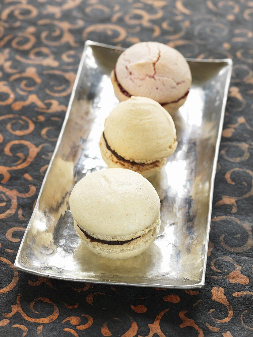 Three macarons with chocolate filling