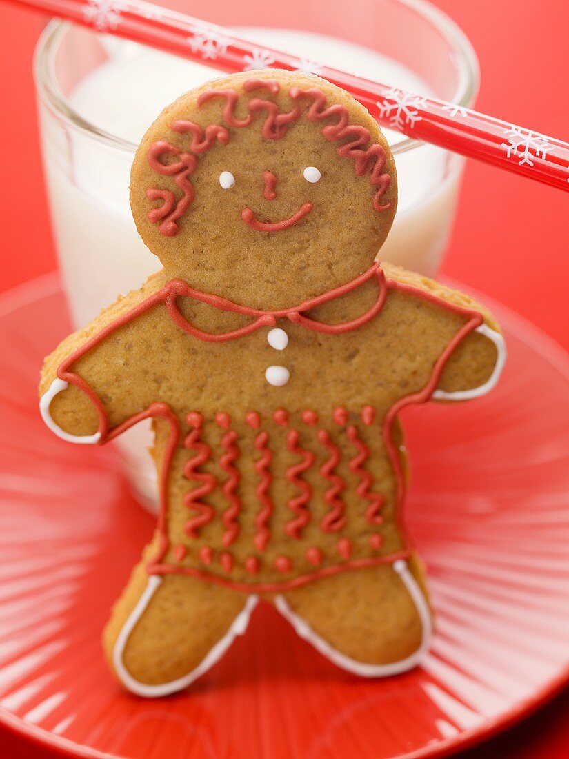Gingerbread man in front of glass of milk