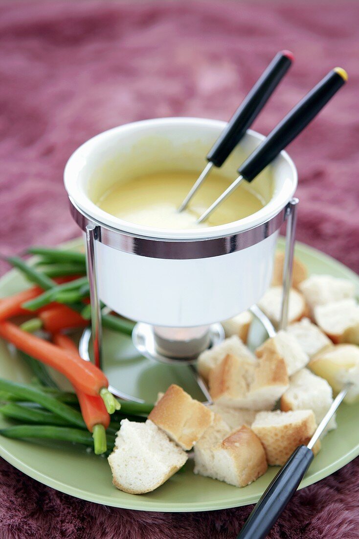 Cheese fondue with vegetables and cubes of bread