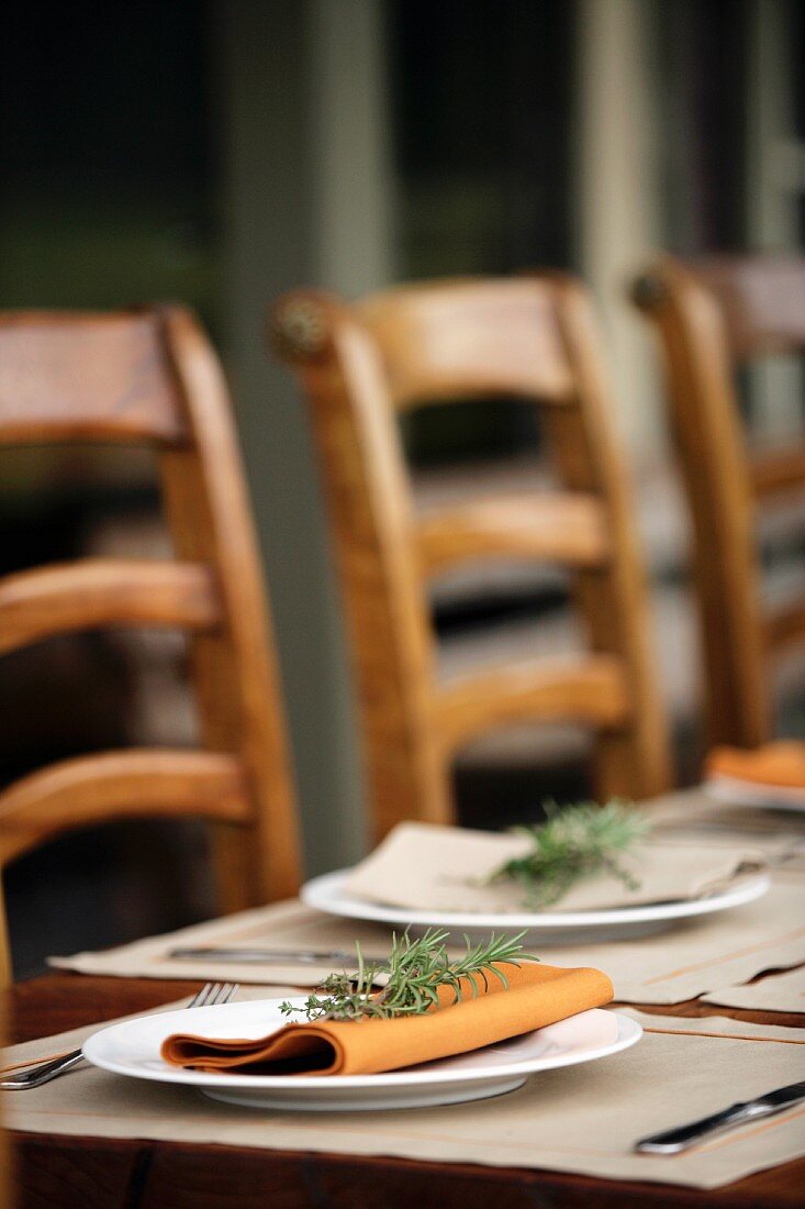 Place-setting on rustic table on terrace