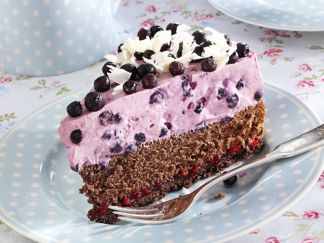 Piece of blueberry cake with chocolate shavings