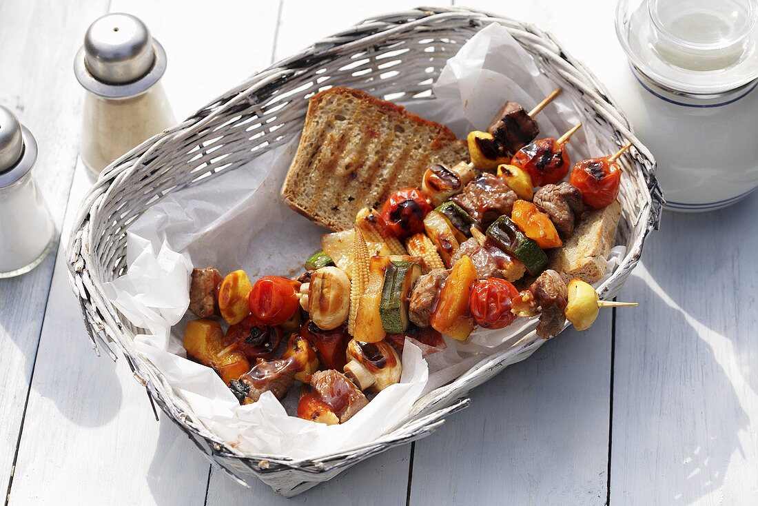Barbecued mixed kebabs with bread in bread basket