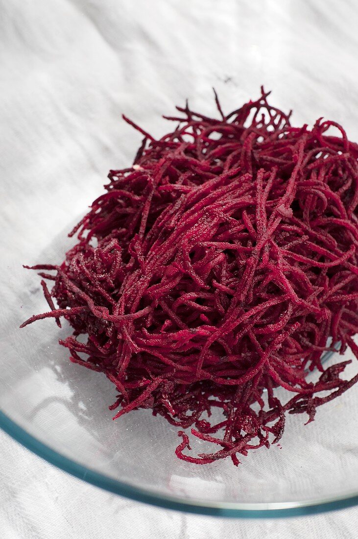 Grated beetroot on glass plate