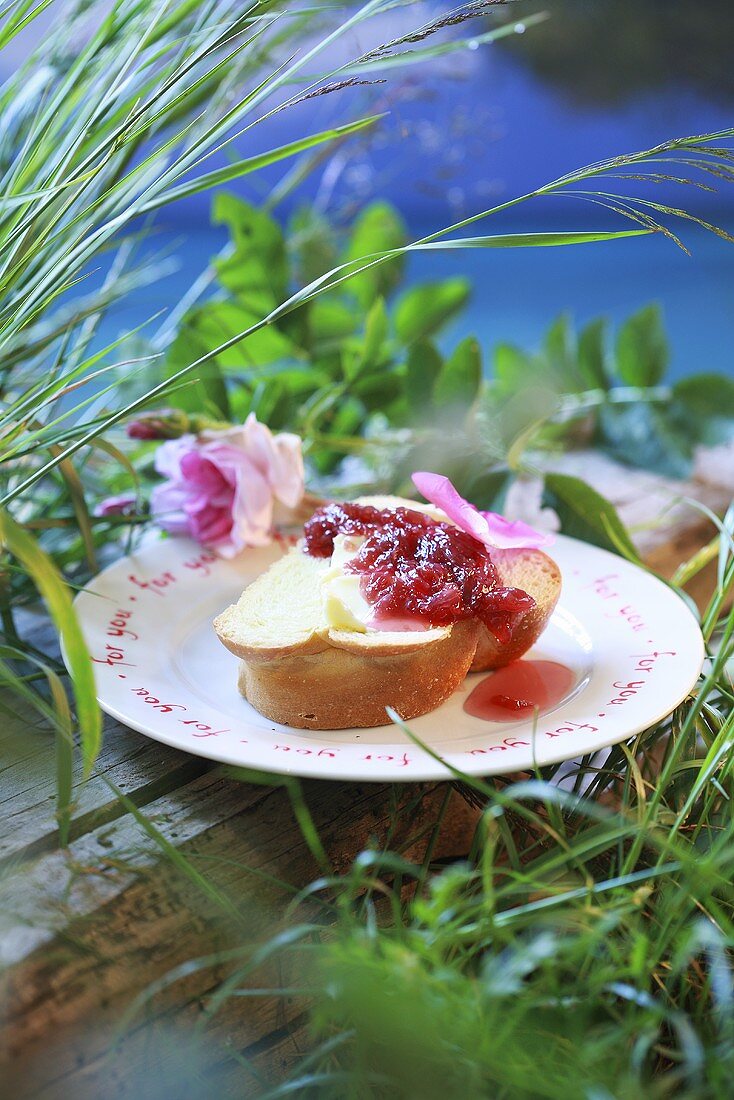 Slice of bread plait with rose jam
