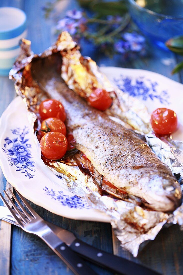 Trout with rosemary and cherry tomatoes in foil