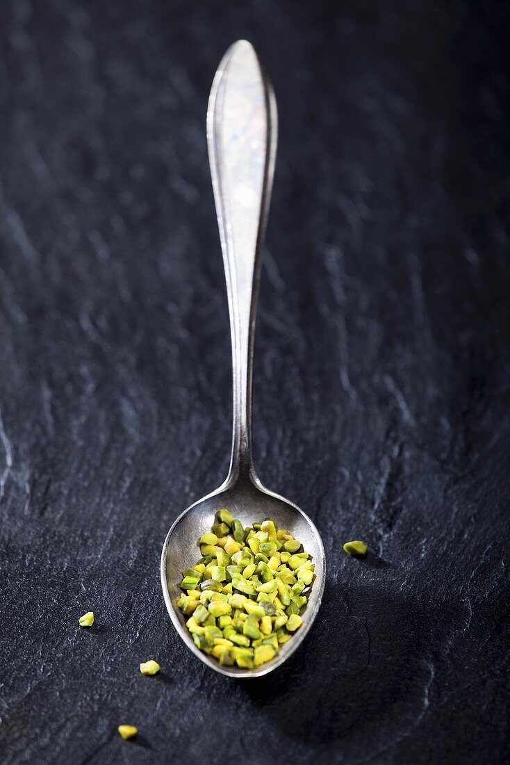 Chopped pistachios on a spoon